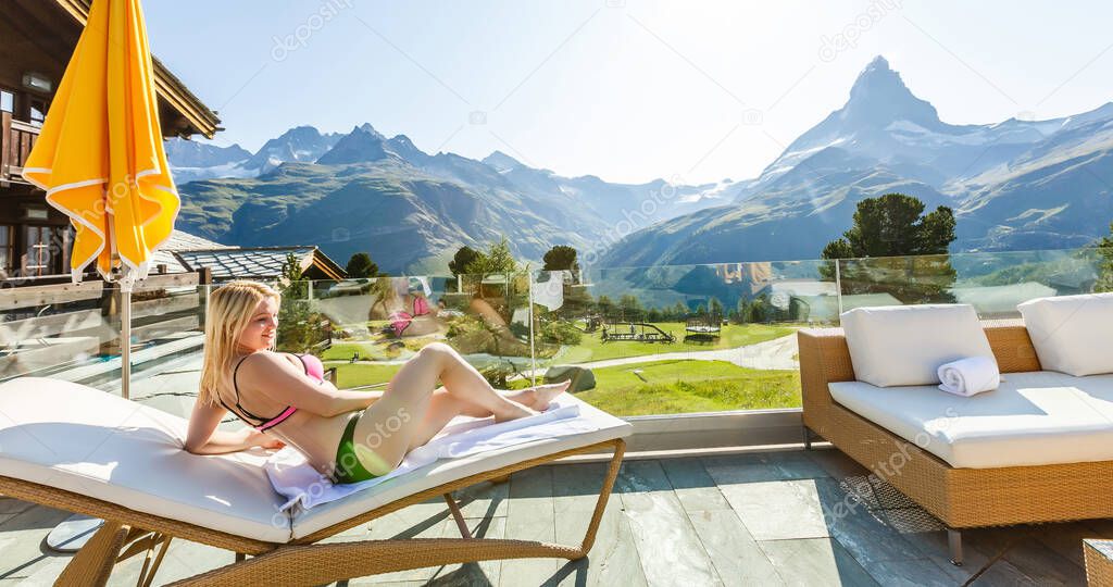 Outdoor alpine spa pool with mountain panorama